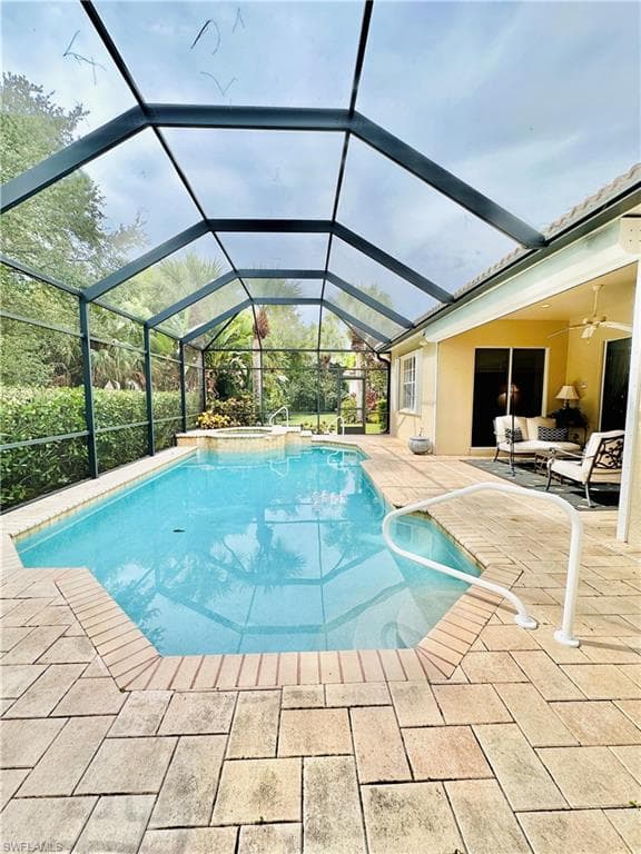 View of pool with a patio and a lanai
