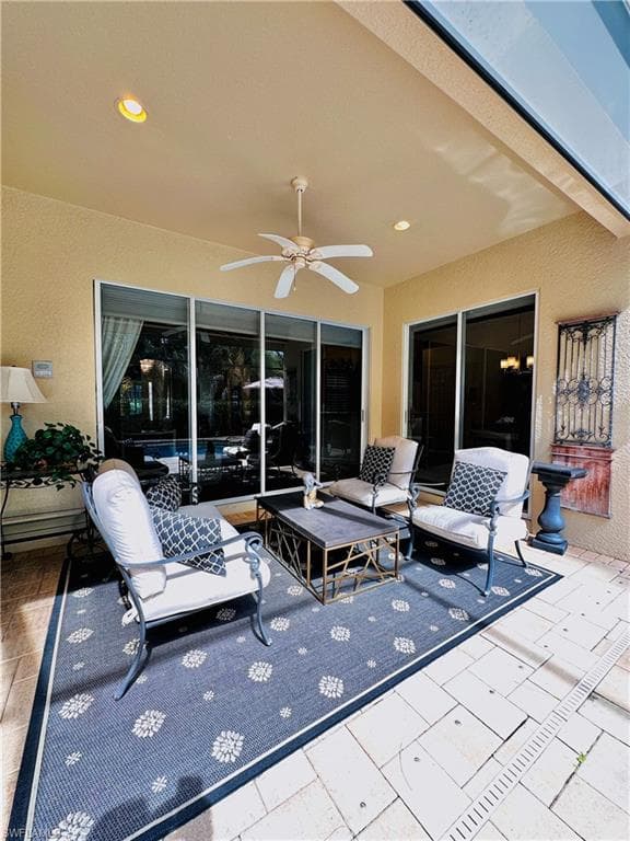 View of patio featuring ceiling fan