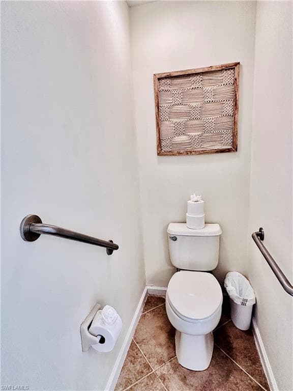 Bathroom featuring toilet and tile patterned flooring