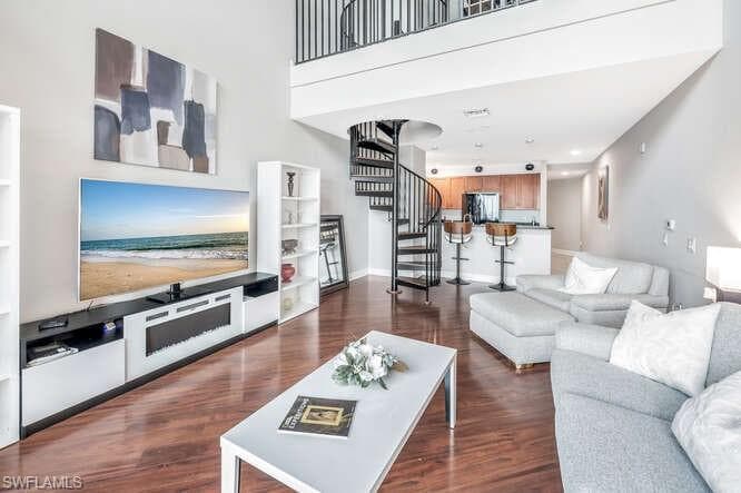 Living room with dark hardwood / wood-style floors