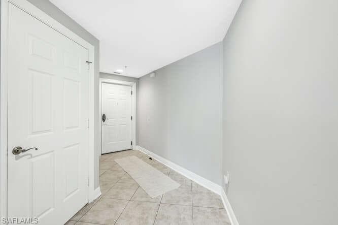 Corridor featuring light tile patterned floors