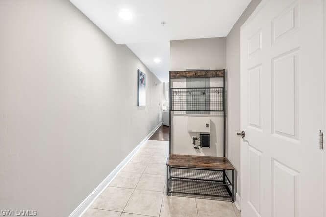 Hallway featuring light tile patterned floors