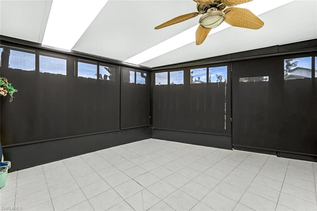 Unfurnished sunroom with ceiling fan and a healthy amount of sunlight