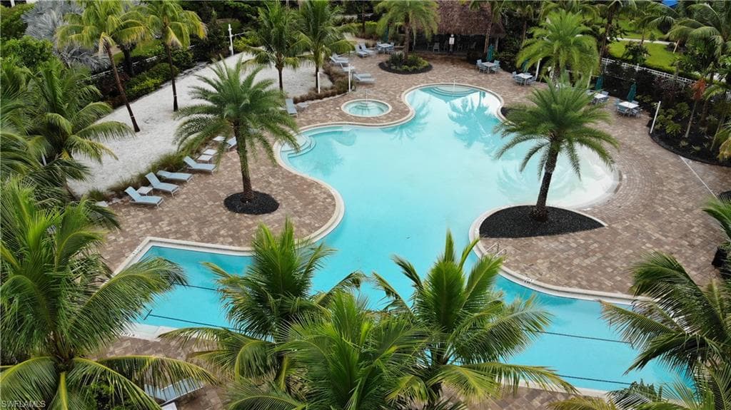 View of pool featuring a patio and a hot tub