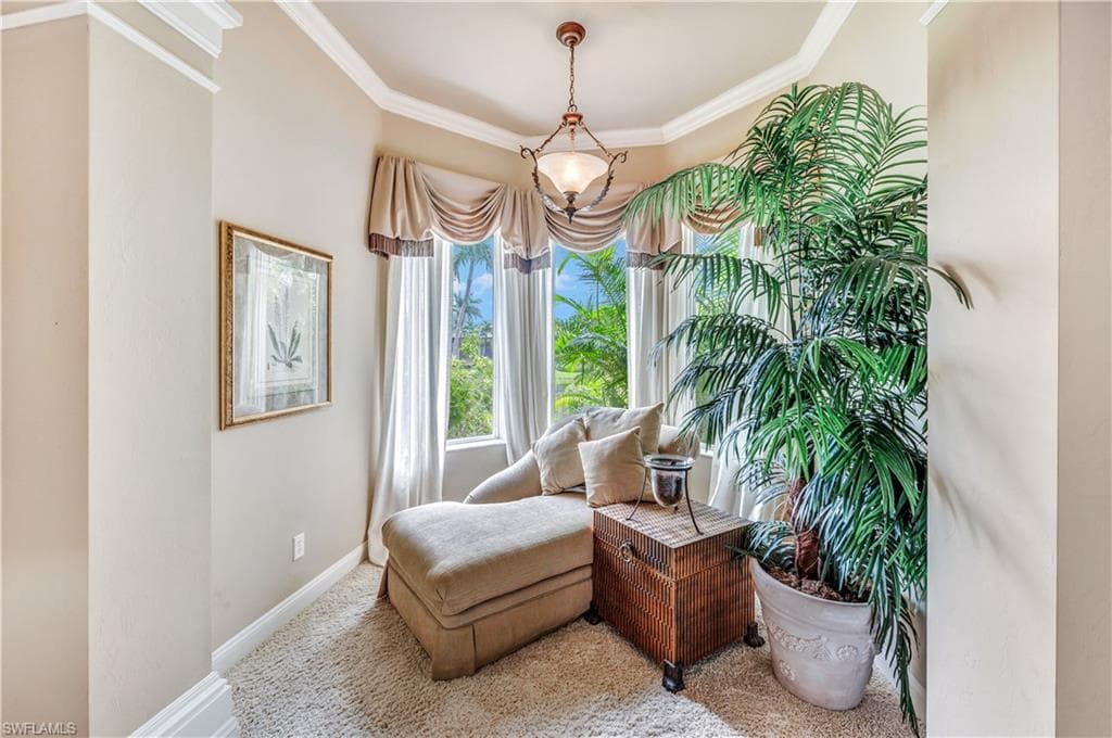 Sitting room featuring crown molding and carpet flooring
