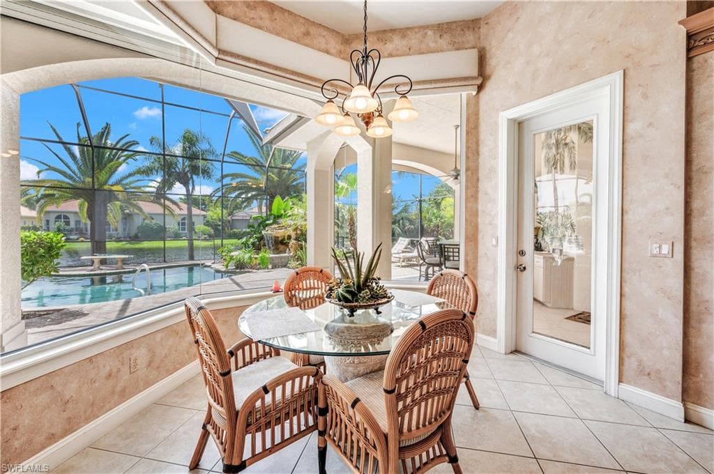 Dining space featuring light tile patterned floors and an inviting chandelier