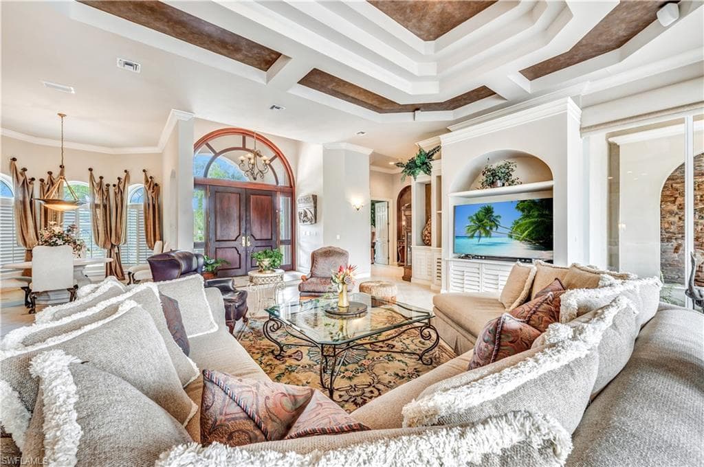 Living room featuring hardwood / wood-style flooring and crown molding