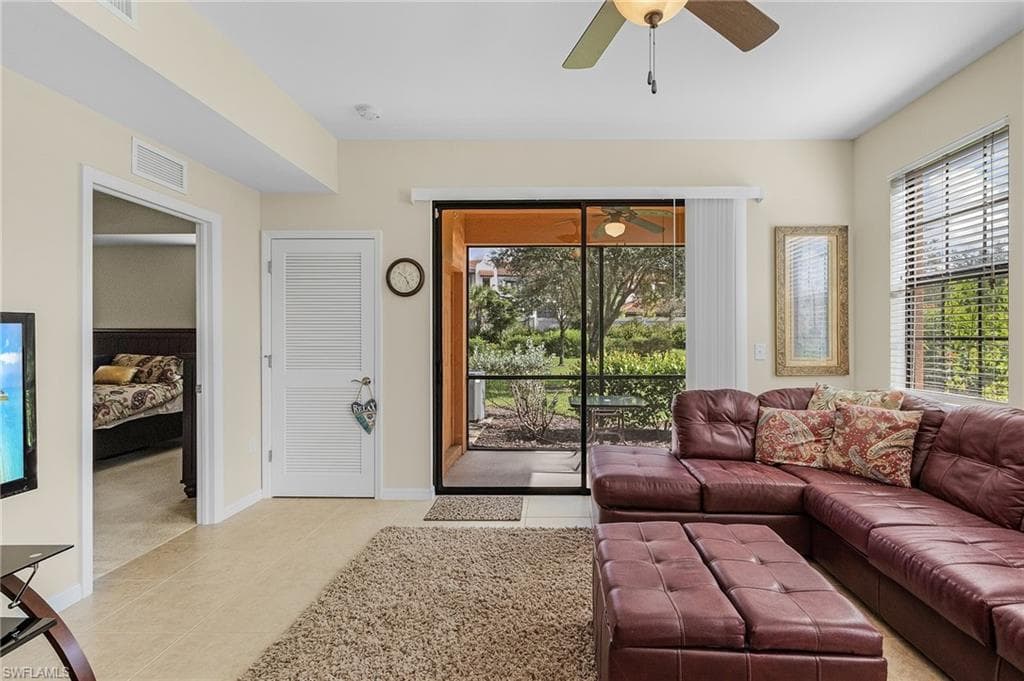 Tiled living room featuring ceiling fan