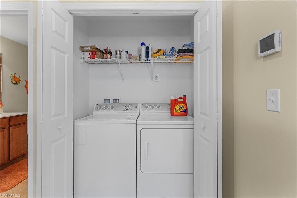 Laundry room with washing machine and clothes dryer