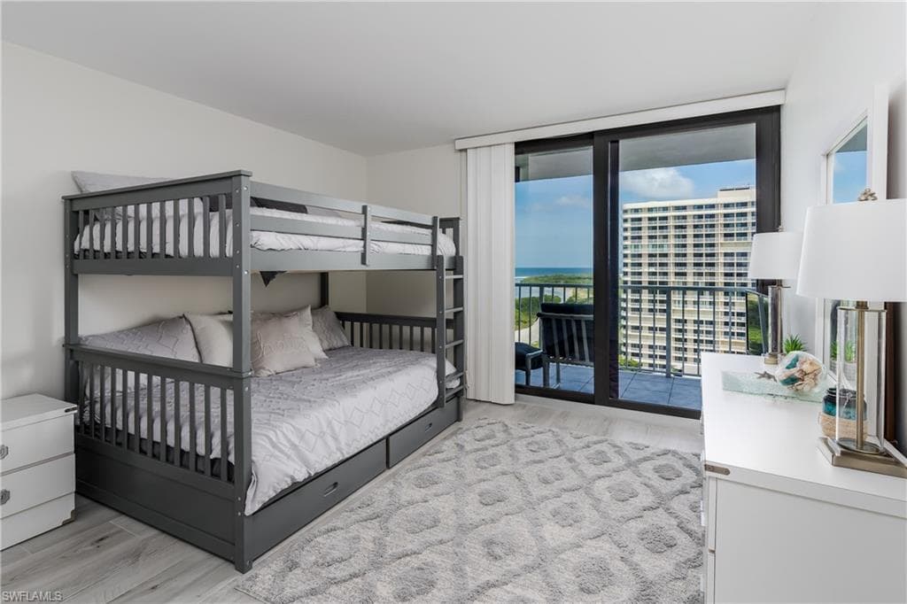 Bedroom with access to outside and light hardwood / wood-style floors