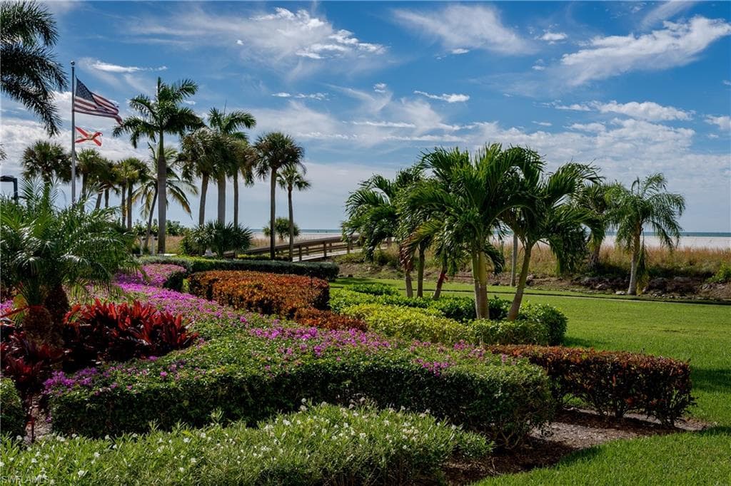 View of property's community with a yard