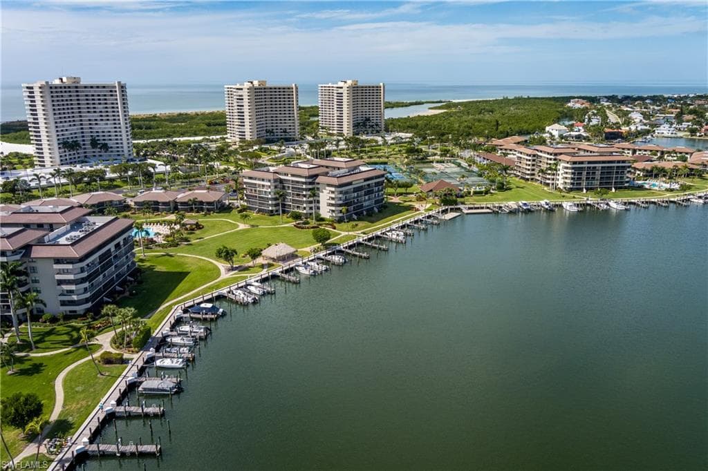 Birds eye view of property with a water view