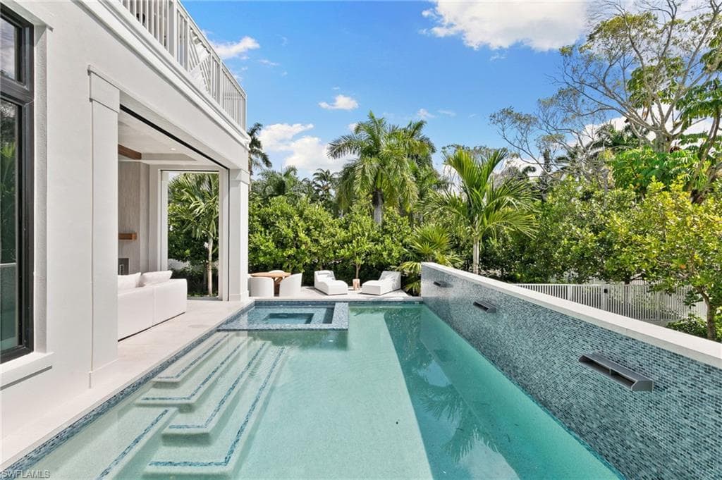 Spectacular Outside Pool, Wall of Blue Tile offers bring the soothing sounds of trickling Waterfalls and integrated Spa