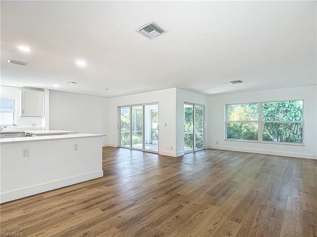 Unfurnished living room with hardwood / wood-style flooring