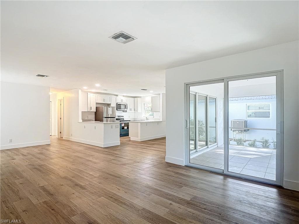 Unfurnished living room with hardwood / wood-style floors