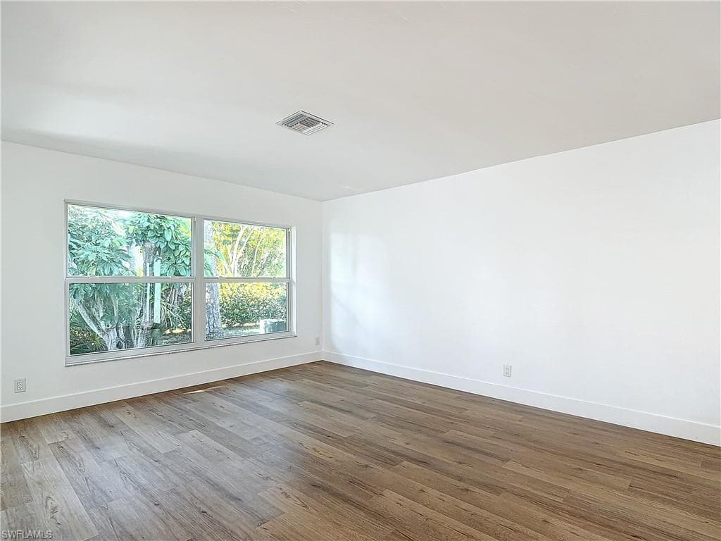 Spare room featuring hardwood / wood-style flooring