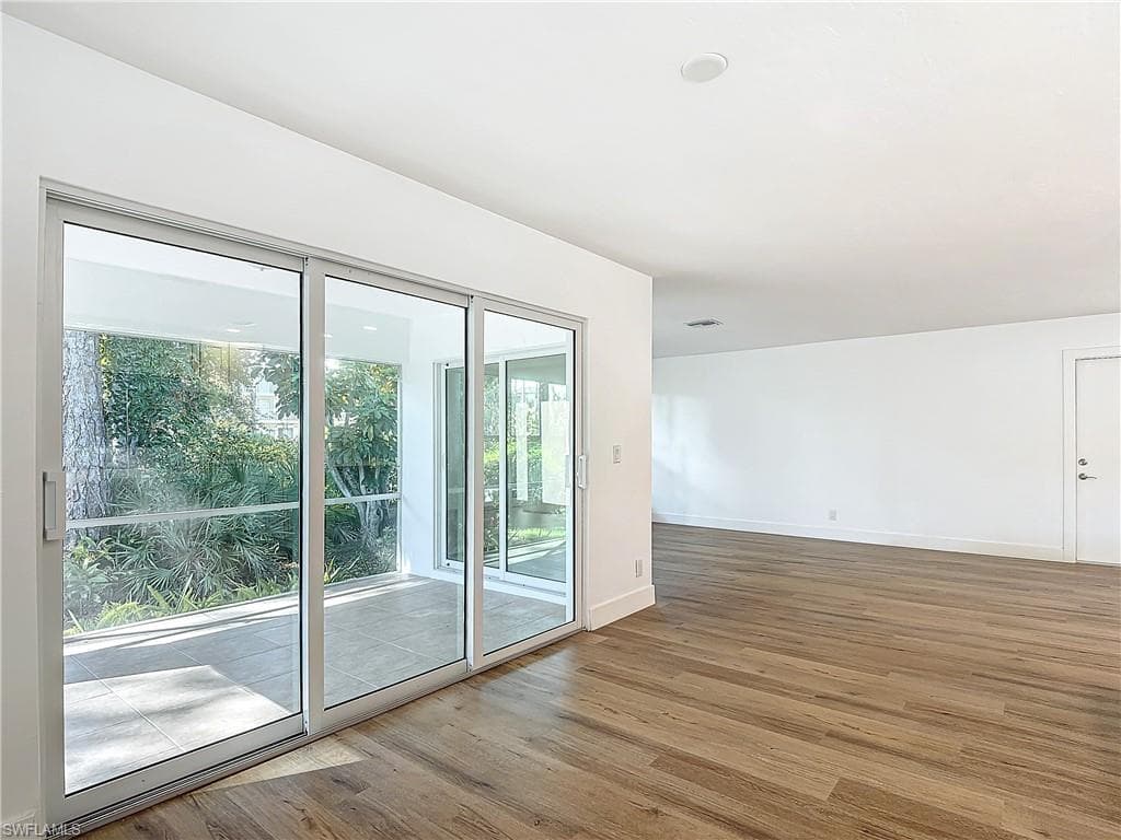 Unfurnished room featuring light hardwood / wood-style floors and a wealth of natural light