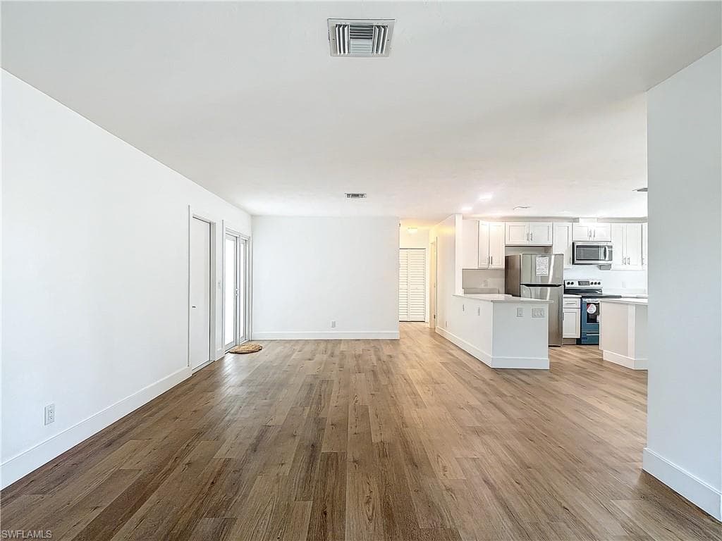 Unfurnished living room with light wood-type flooring