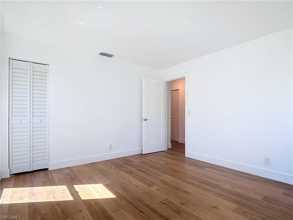 Unfurnished bedroom with a closet and light hardwood / wood-style floors