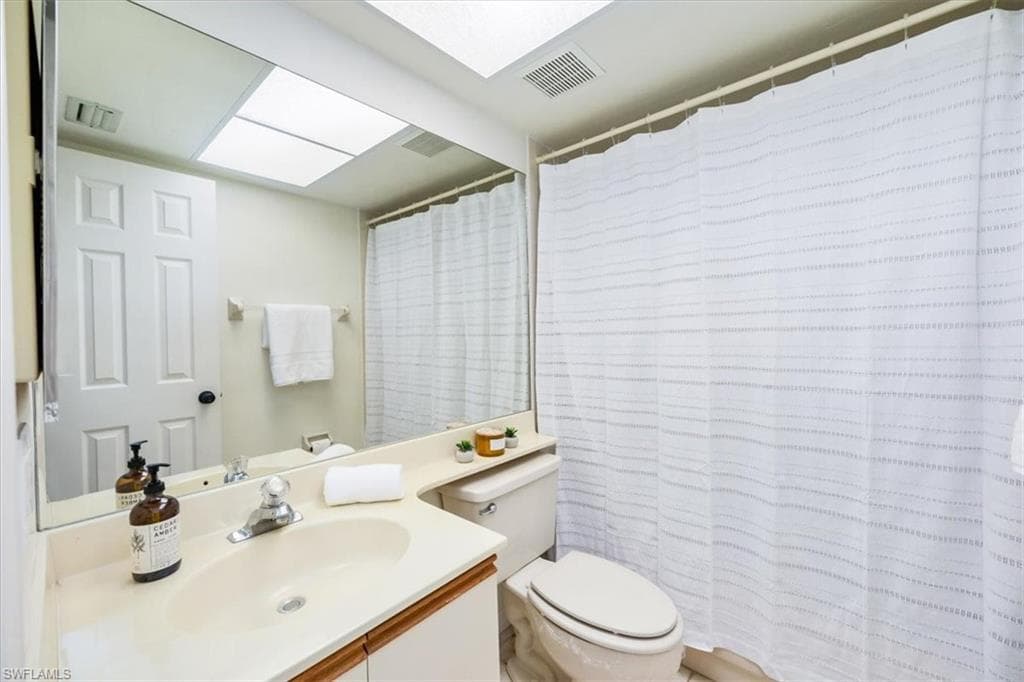 Guest bathroom has a shower over tub