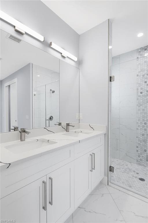 Bathroom featuring vanity and a shower with shower door