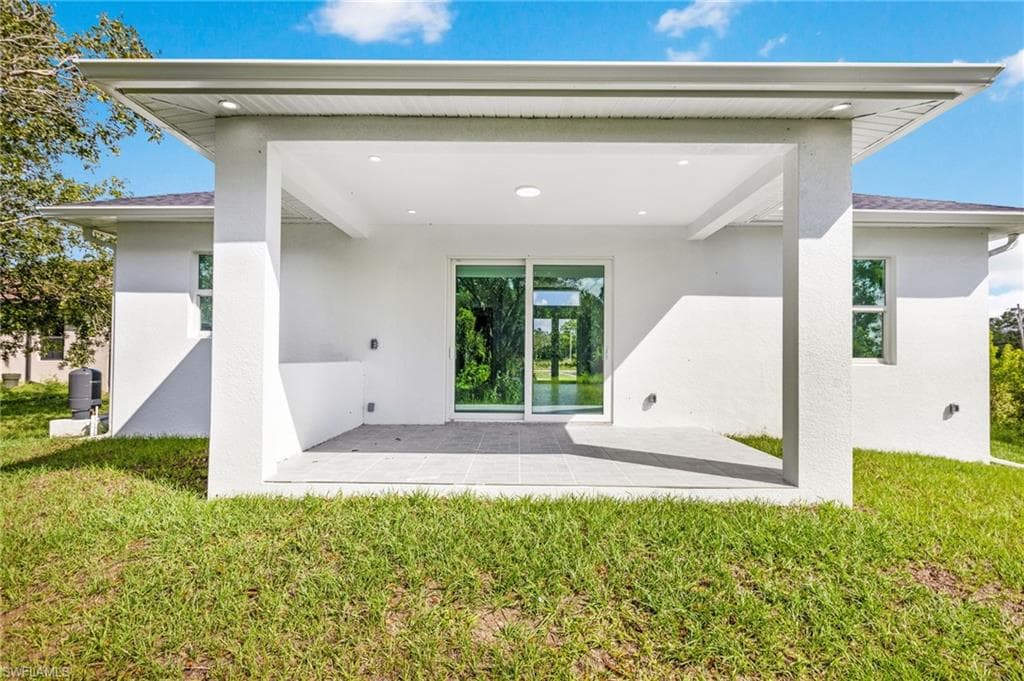 Back of house featuring a patio area and a yard