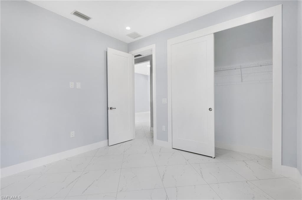 Unfurnished bedroom featuring a closet
