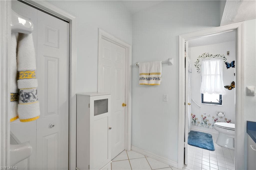 Bathroom featuring tile patterned floors and toilet
