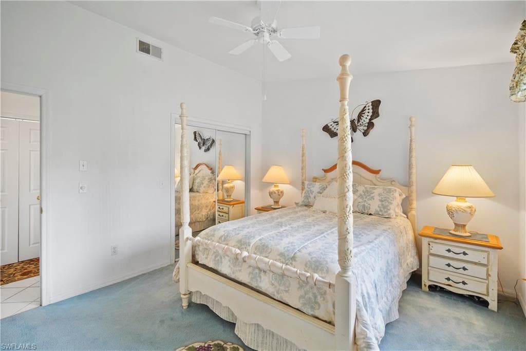 Carpeted bedroom featuring a closet and ceiling fan