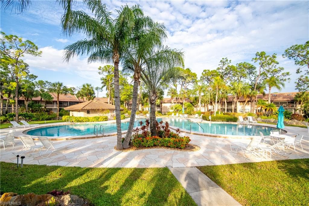 View of pool featuring a patio and a lawn