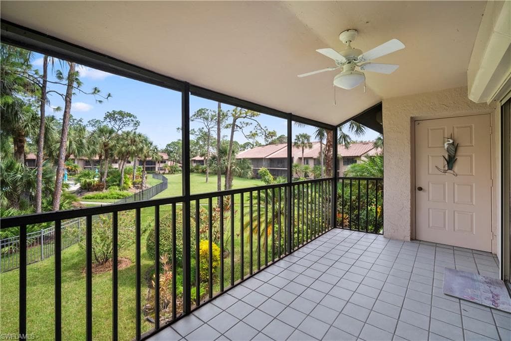 Unfurnished sunroom featuring ceiling fan