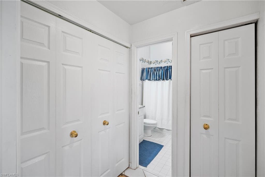 Hall featuring tile patterned floors