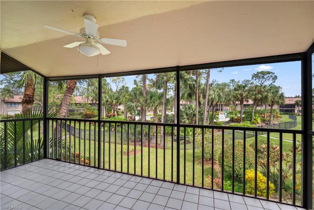 Unfurnished sunroom featuring ceiling fan