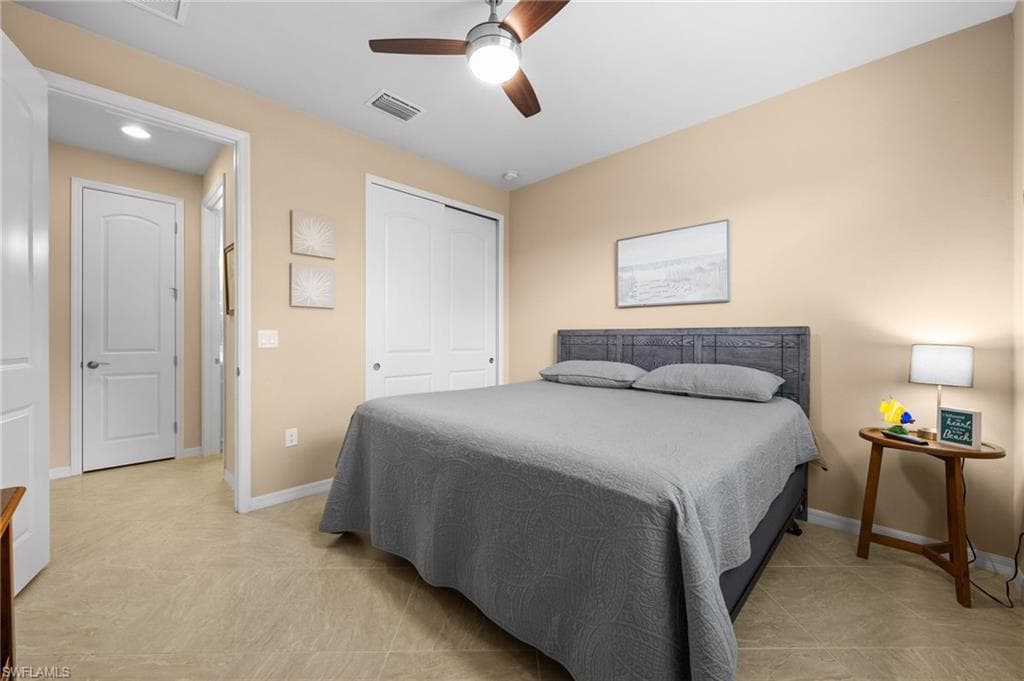 Bedroom with ceiling fan and a closet