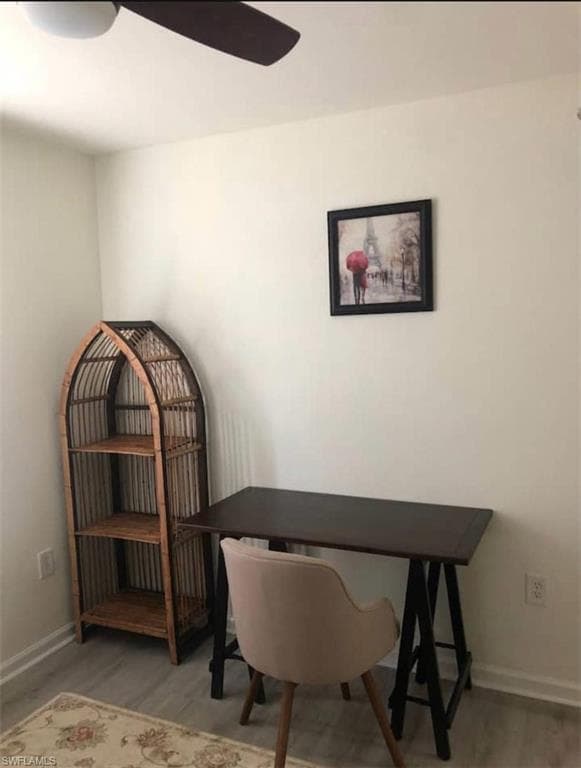 Home office featuring ceiling fan and wood-type flooring