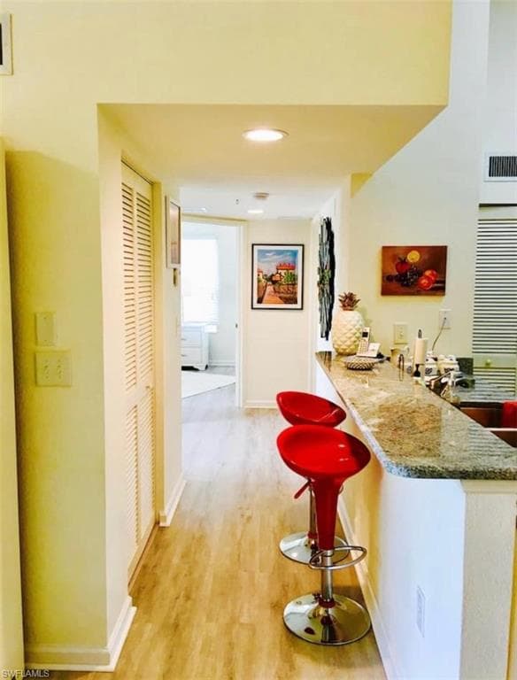 Corridor with light hardwood / wood-style floors