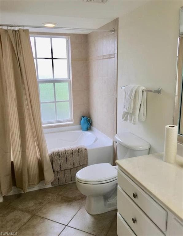 Bathroom featuring vanity, tile patterned floors, and toilet