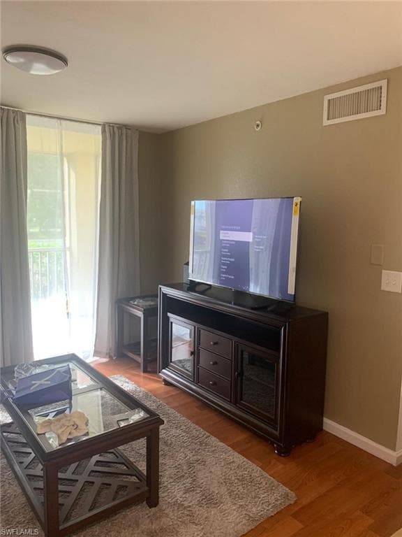 Living room with wood-type flooring