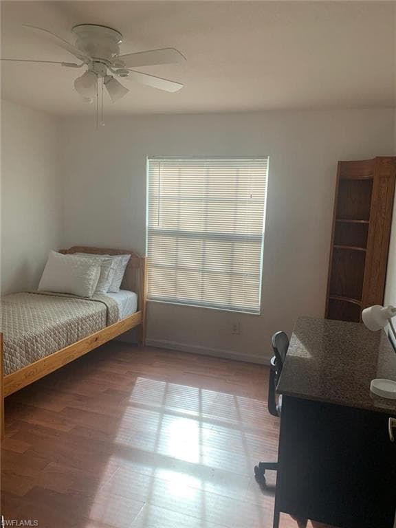 Bedroom featuring wood-type flooring and ceiling fan