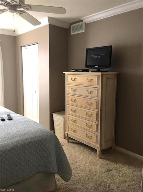 Bedroom featuring ornamental molding, carpet, and ceiling fan
