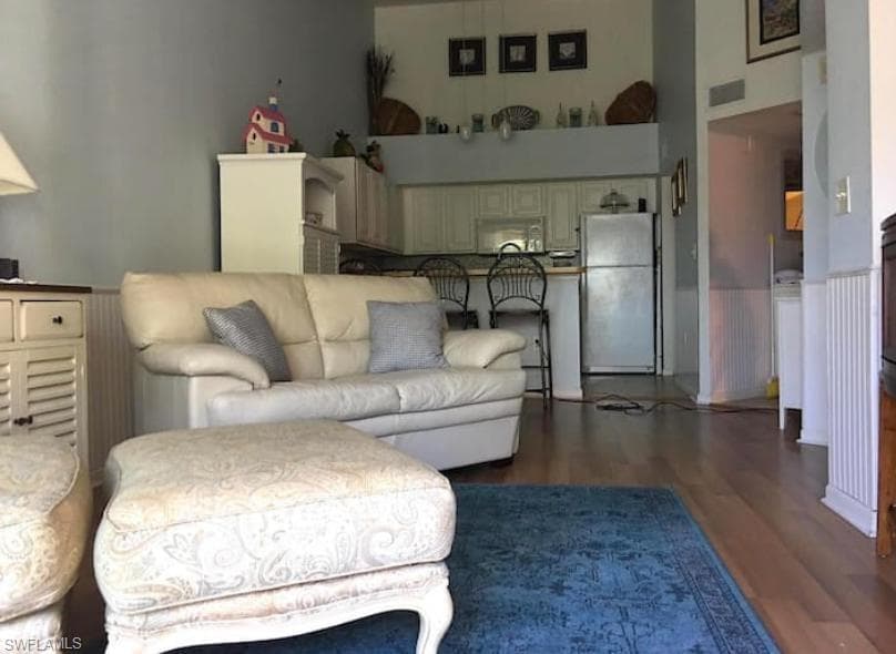 Living room featuring dark hardwood / wood-style flooring