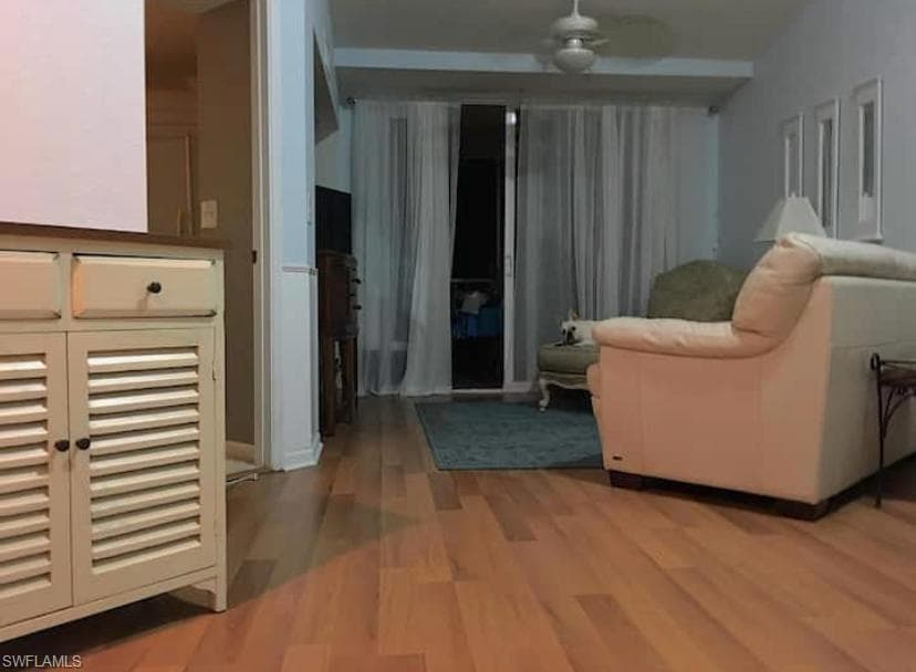 Sitting room with light hardwood / wood-style flooring and ceiling fan
