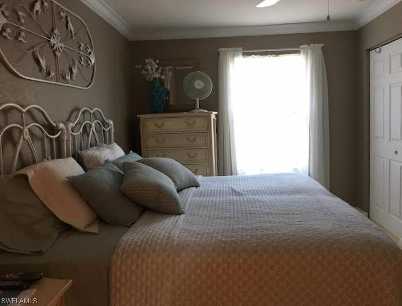 Bedroom with a closet and crown molding