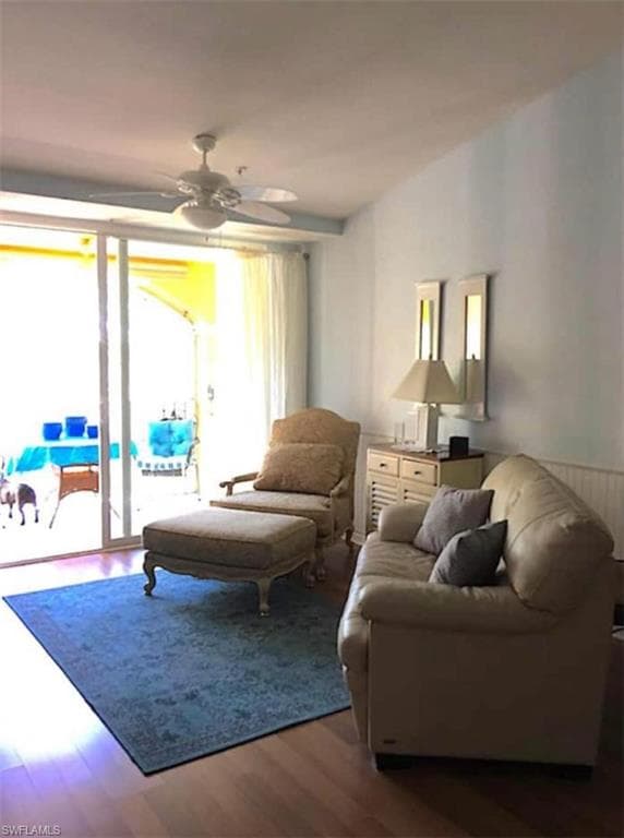 Living room with hardwood / wood-style floors and ceiling fan