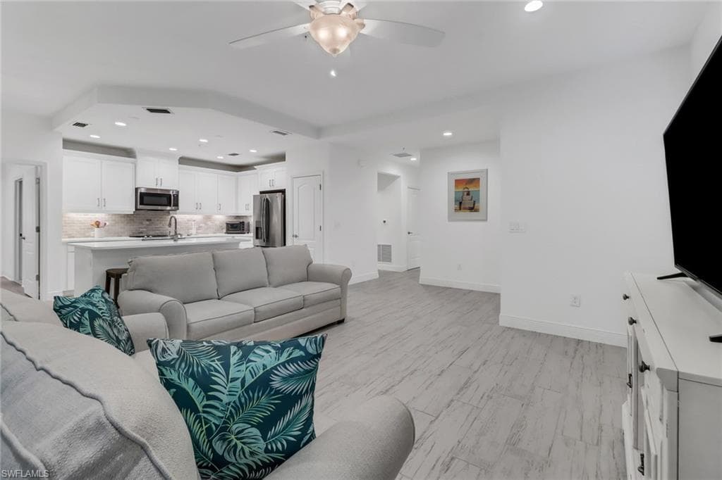 Living room and kitchen featuring open concept