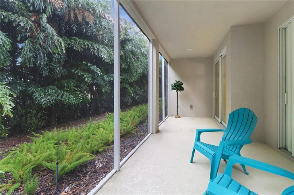 Large screened lanai overlooking lush landscape