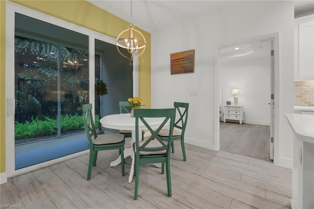 Dining space with light hardwood type tile floors