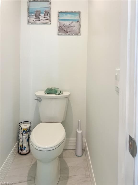 Bedroom featuring connected bathroom, light colored carpet, and ceiling fan