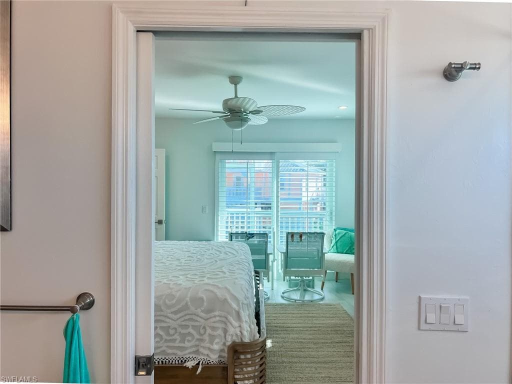 Laundry room featuring washer and clothes dryer, cabinets, water heater, and light tile patterned flooring