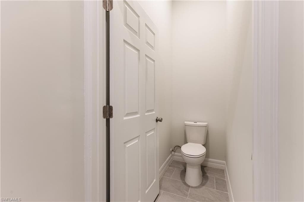 Bathroom featuring light tile patterned floors and baseboards